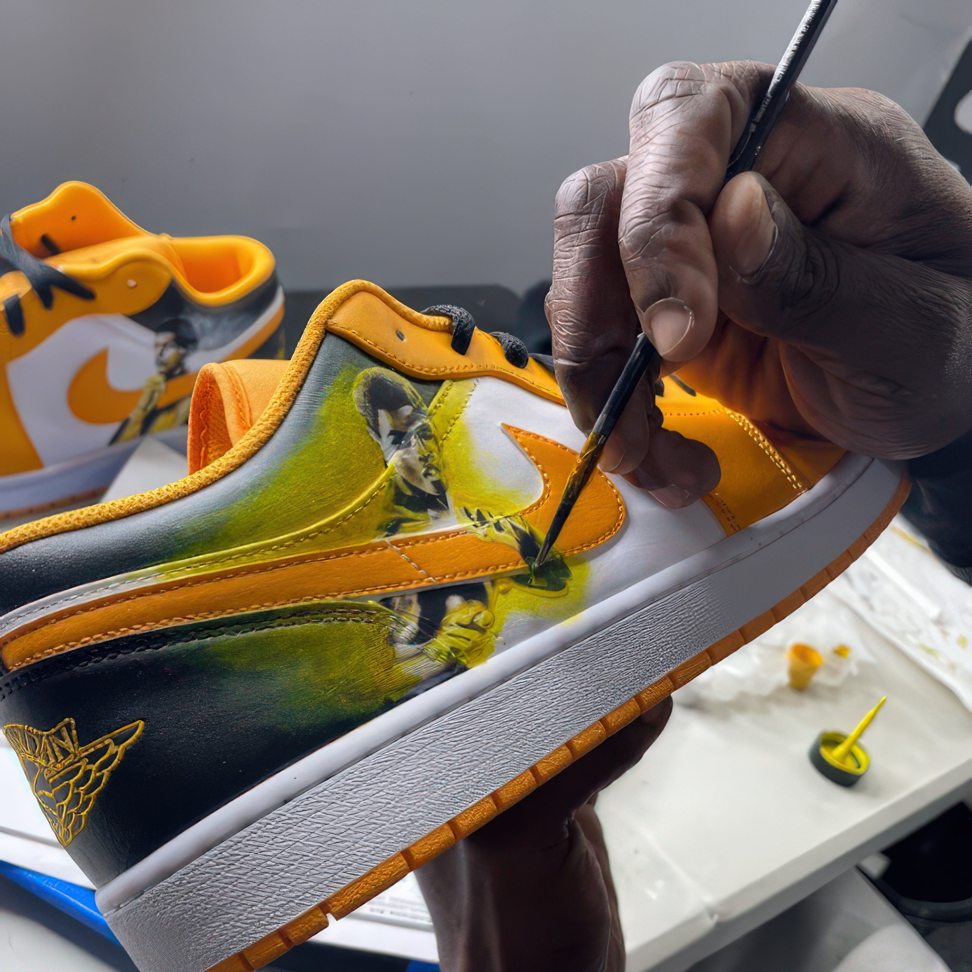 Person painting a colorful sneaker with a brush